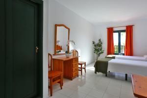 a bedroom with a bed and a dresser and a mirror at Nazaret Sol in Costa Teguise +40 photos