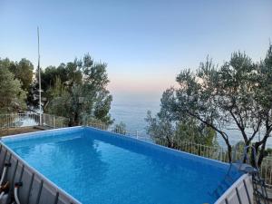 a swimming pool with a view of the ocean at CASA OLEANDRO in Finale Ligure