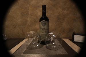 a bottle of wine sitting on a table with two wine glasses at Casita La Glorieta in Peñafiel