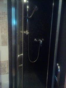 a shower in a bathroom with a glass door at Welsh Homestay in Cardiff