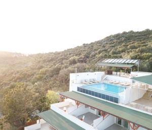a house with a swimming pool and a mountain at Blue Island Luxury Hotel Adults Only in Kaş