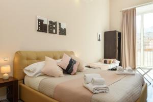 a bedroom with two beds with towels on them at Domus Angioina in Naples
