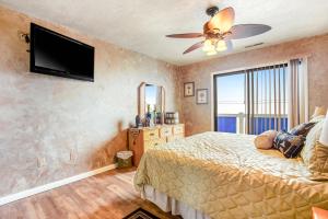 a bedroom with a bed and a flat screen tv at East of the Sun --- 39620 East Sun Drive #726 in Fenwick Island +26 photos