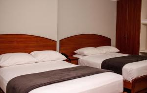 Postel nebo postele na pokoji v ubytování Grand Hotel Machala