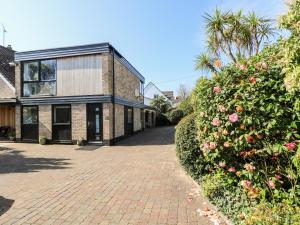 a brick driveway in front of a house at Little Beach House in St Austell