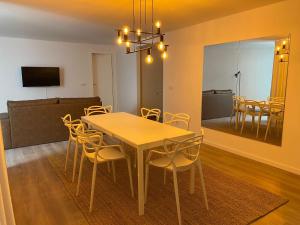 a dining room with a table and chairs and a couch at CITY STAYS BELÉM APARTMENTS in Lisbon