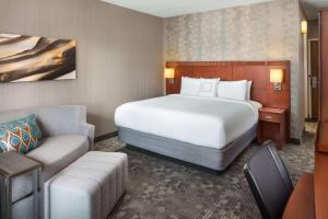 a hotel room with a bed and a couch at Sonesta Select Laguna Hills Irvine Spectrum in Laguna Hills
