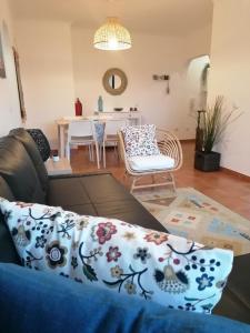 a living room with a couch and a table at Apartamento Riomar in Vila Nova de Milfontes