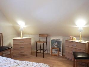 a bedroom with two dressers and a bed with two lamps at 4 person holiday home in SLITE in Slite