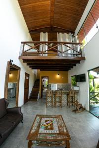 a living room with a couch and a table at Pousada e Restaurante Mangue Seco Angra in Angra dos Reis