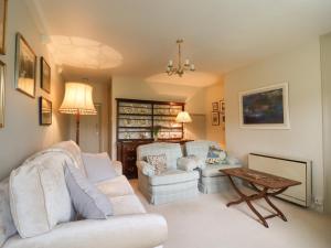 a living room with two white couches and a table at The Nook Bank Newton in Bell Busk