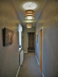 an empty hallway with a hallway at Valhalla Brae, 3 Bed House on NC500 with Beautiful Castle and Sea Views in Keiss
