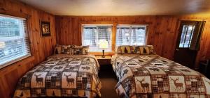 A bed or beds in a room at The Wilderness Inn: Chalets