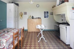 a kitchen with a table and a small table in a room at Lorraine country house near Lake Madine, Lahayville in Lahayville