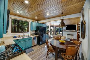 a kitchen with blue cabinets and a table and chairs at Cabana Del Rio in Guerneville