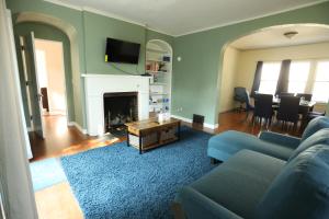 a living room with a couch and a fireplace at Blue House, Blocks from Ross-Aide, Mackey, Samara House, Birck Golf Complex in West Lafayette