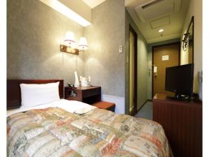 a hotel room with a bed and a flat screen tv at Tokyo Inn - Vacation STAY 11113v in Tokyo