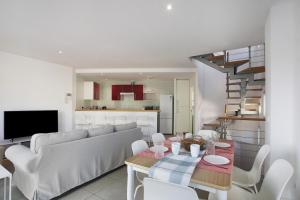ein Wohnzimmer mit einem Sofa und einem Tisch in der Unterkunft Beautiful Duplex Facing The Beach in El Médano