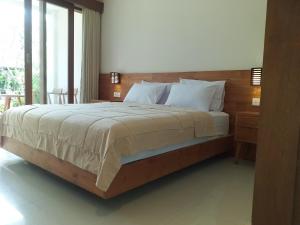 Postel nebo postele na pokoji v ubytování Kama Ayu Bungalow