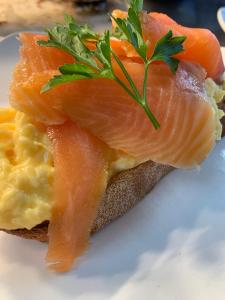 a sandwich with salmon and eggs on a plate at The Waterfront Wynyard in Wynyard