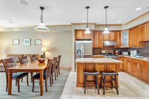 a kitchen and dining room with a wooden table and chairs at Modern Condo - Great Location! in Bear Valley