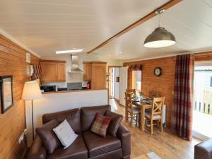 a living room with a couch and a table at Ramblers' Rest Lodge in Windermere