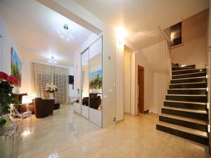 a lobby with a staircase and a living room at Villa Maranata-5 stars-pool-spa-gym-free parking-privacy in Jesenice