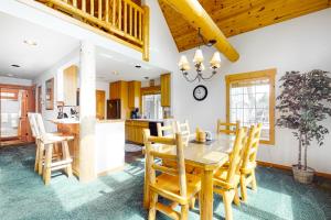 a kitchen and dining room with a wooden table and chairs at Cinnamon Teal Chalet in Redmond