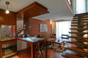a kitchen and living room with a spiral staircase at Park Plaza Apart Hotel in Santiago