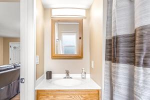 a bathroom with a sink and a mirror at Bungalow on Boyd in Coeur d'Alene +11 photos