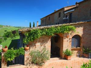 a building with vines on the side of it at Luxurious Farmhouse in Montalcino with Pool in Montalcino