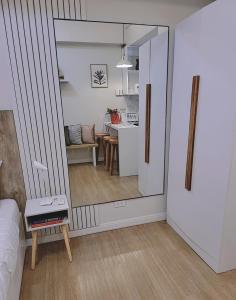 a room with a mirror and a living room at SHERISSE' CONDO @ THE LOOP WITH WIFI,CABLE AND HOT & COLD SHOWER, in Cagayan de Oro