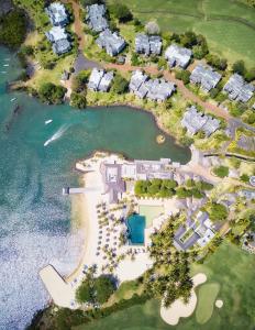 an aerial view of a mansion on the water at Anahita Golf & Spa Resort in Beau Champ