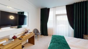 a hotel room with a bed and a large mirror at HOTEL ANGEL SOFIA in Fălticeni