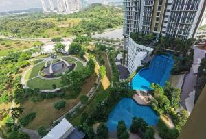 an aerial view of a building with a swimming pool at The Elysia Suites in Nusajaya