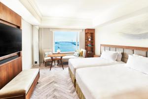 a hotel room with two beds and a television at InterContinental Tokyo Bay by IHG in Tokyo