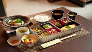 a table with a tray of food and bowls of food at InterContinental Tokyo Bay by IHG in Tokyo