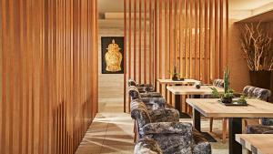 a row of tables and chairs in a restaurant at InterContinental Tokyo Bay by IHG in Tokyo