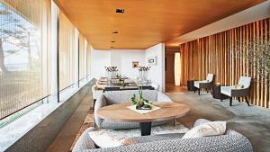 a living room with couches and a table at InterContinental Tokyo Bay by IHG in Tokyo