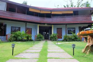 a building with a pathway in front of it at Keyun's Inn- Across Cloud 9 in General Luna