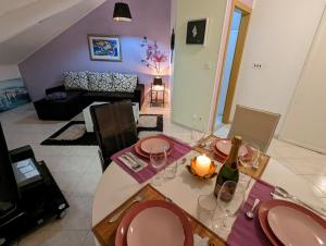 ein Wohnzimmer mit einem Tisch und Weingläsern darauf in der Unterkunft Bellino penthouse in Korčula