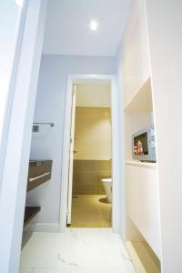 a hallway leading to a bathroom with a toilet at NM Home Da Nang in Da Nang