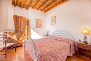 a bedroom with a bed and a table and a chair at Usignoli Apartments - Happy Rentals in Reggello
