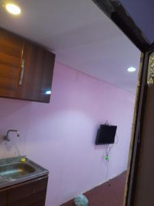 a kitchen with a sink next to a wall at Alkithri Apartments for Singls in Muhayil