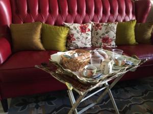 a tray of food on a table in front of a couch at Suite Carducci B&B - Residence in Rutigliano