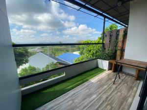 an apartment balcony with a view of the yard at 88 ลิฟวิ่ง โฮเทล ปากช่อง in Ban Sathani Bandai Ma