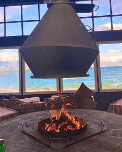 a large chandelier hanging over a table with a fire pit at Sevan - Tsovazard Beach House in Tsovazard