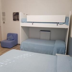 a room with two bunk beds and a bed at Albergo La Marinella in Varazze