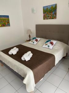 a bedroom with a bed with towels on it at Ti Sucrier Marina de Saint Francois in Saint-François