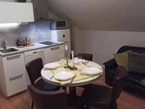 a small kitchen with a table and chairs and a kitchen with a table and chairs at Cosy Loft in Helsinki